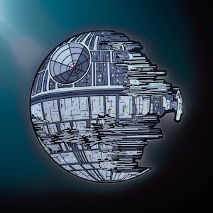 May include: A gray and black embroidered patch of the Death Star from Star Wars. The Death Star is a large, spherical space station with a distinctive circular opening on one side.