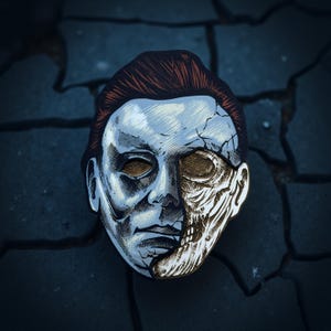 May include: A Halloween-themed mask featuring a split design. One side is a pale, human-like face with brown hair, while the other side reveals a skeletal appearance. The mask has a cracked texture and is set against a dark, cracked background.
