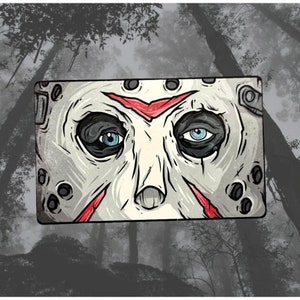 May include: A close-up of a white hockey mask with red slashes and black eyes. The mask is a popular horror movie icon.