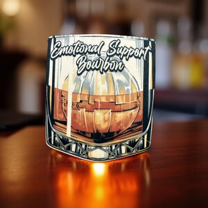 May include: A brown and black glass with a graphic of a glass of bourbon and the text "Emotional Support Bourbon".