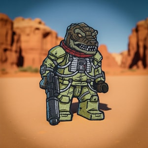 May include: Embroidered patch featuring a reptilian humanoid character in a military-style uniform, holding a gun. The character has a brown head, a red scarf, and a green and yellow uniform. The background shows a desert landscape.