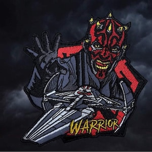 May include: A red and black embroidered patch featuring Darth Maul from Star Wars. He is holding a lightsaber and the text "WARRIOR" is visible in yellow.
