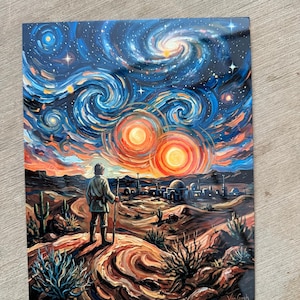 May include: A rectangular art print featuring a figure standing in a desert landscape looking toward a settlement under a swirling night sky with two bright orange suns, painted in a thick, textured style with blue, orange, and yellow hues.