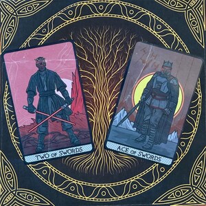 May include: Two tarot cards with a Star Wars theme. The card on the left is the Two of Swords, featuring Darth Maul holding two lightsabers. The card on the right is the Ace of Swords, featuring Darth Vader holding a lightsaber.
