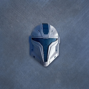 May include: A white and blue helmet with a textured surface. The helmet has a visor and a blue stripe on the top.