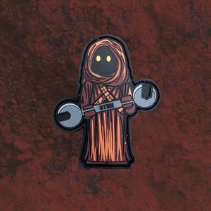 May include: A brown and orange character with a hooded robe and yellow eyes is holding two wrenches. The character is wearing a brown belt with a buckle. The background is a red, brown, and black textured surface.