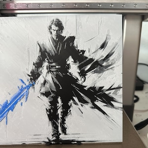 May include: A black and white painting of a figure in a dark robe holding a blue lightsaber. The background is a white canvas with black brushstrokes.
