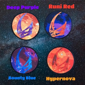 May include: Four round patches with a stylised space-themed design. The patches are in four different colour schemes: deep purple, rumi red, bounty blue, and hypernova. Each patch features a crescent moon shape with a galaxy background.