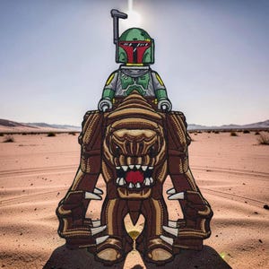 May include: An embroidered patch featuring a green and grey armoured character with a helmet riding a large, brown, multi-limbed creature with sharp white claws and an open mouth showing red interior details, set against a desert landscape background.