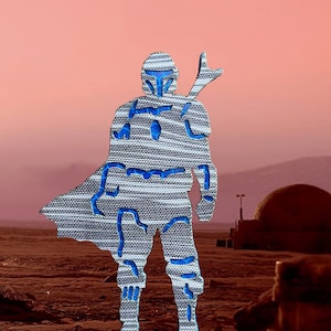 May include: A blue and gray silhouette of a Mandalorian warrior standing in a desert landscape. The warrior is wearing a helmet and armor, and is holding a weapon. The background is a dusty, reddish-brown color.