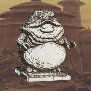 May include: A black and white illustration of a Jabba the Hutt character from Star Wars, standing on a Lego base.