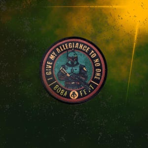 May include: A round, red, white, and black patch with the text "I give my allegiance to no one Boba Fett" and a cartoon image of Boba Fett in his Mandalorian armor.