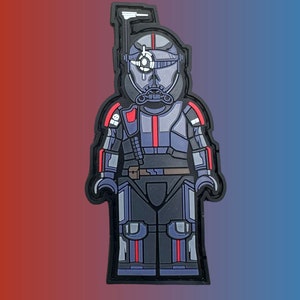 May include: A black and red Lego-style figure of a Star Wars clone trooper with a white visor and a red stripe on the chest.