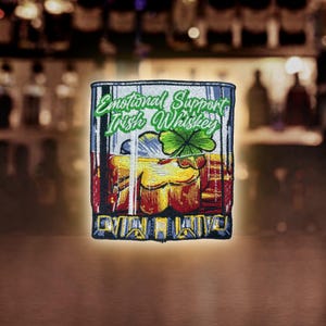 May include: A colorful embroidered patch depicting a glass of Irish whiskey with a shamrock on top. The text on the patch reads "Emotional Support Irish Whiskey".