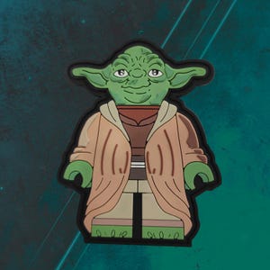 May include: A green and brown Yoda Lego minifigure patch. The patch is made of rubber and has a black outline.
