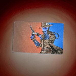 May include: A blue-skinned character wearing a brown cowboy hat and coat, holding a gun in their right hand. The character is standing in front of a red and blue background.