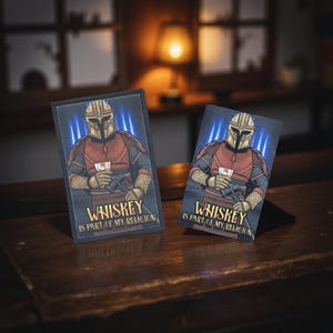 May include: Two rectangular art prints featuring a Mandalorian-style character holding a whiskey glass. The character is depicted in a red and gray outfit with a helmet. The text "Whiskey is part of my religion" is printed below the image.