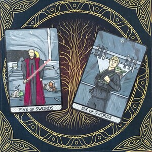 May include: Two tarot cards, "Five of Swords" and "Six of Swords", from a Star Wars themed deck. The Five of Swords card depicts a character in a red robe standing over a fallen figure, while the Six of Swords card shows a character carrying a small creature on their back.