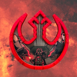 May include: A red Rebel Alliance symbol made of Lego bricks with a Star Wars image inside. The image shows Darth Vader with a red lightsaber in a dark space setting.