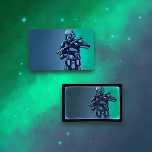 May include: A black and white illustration of a Star Wars Stormtrooper with a green glow. The Stormtrooper is holding a blaster rifle and is wearing a helmet. The illustration is on a black background.