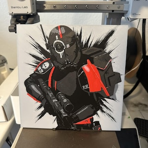 May include: A black and red 3D printed model of a Star Wars Stormtrooper with a white background. The model is printed on a white platform with a black base.