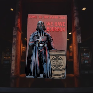 May include: A rectangular sign featuring Darth Vader holding a drink, with the text "COME TO THE DARK SIDE WE HAVE BOURBON." A wooden barrel with "IMPERIAL BOURBON" is next to him. The sign has a red background.