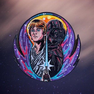 May include: A colorful embroidered patch featuring a portrait of Luke Skywalker and Darth Vader, with a lightsaber and a swirling galaxy background.