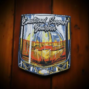 May include: Embroidered patch with a glass of amber liquid and the text "Emotional Support Bourbon".