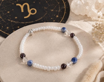 Tobillera de Capricornio: Joyería zodiacal con cuentas de granate, cuarzo y sodalita.