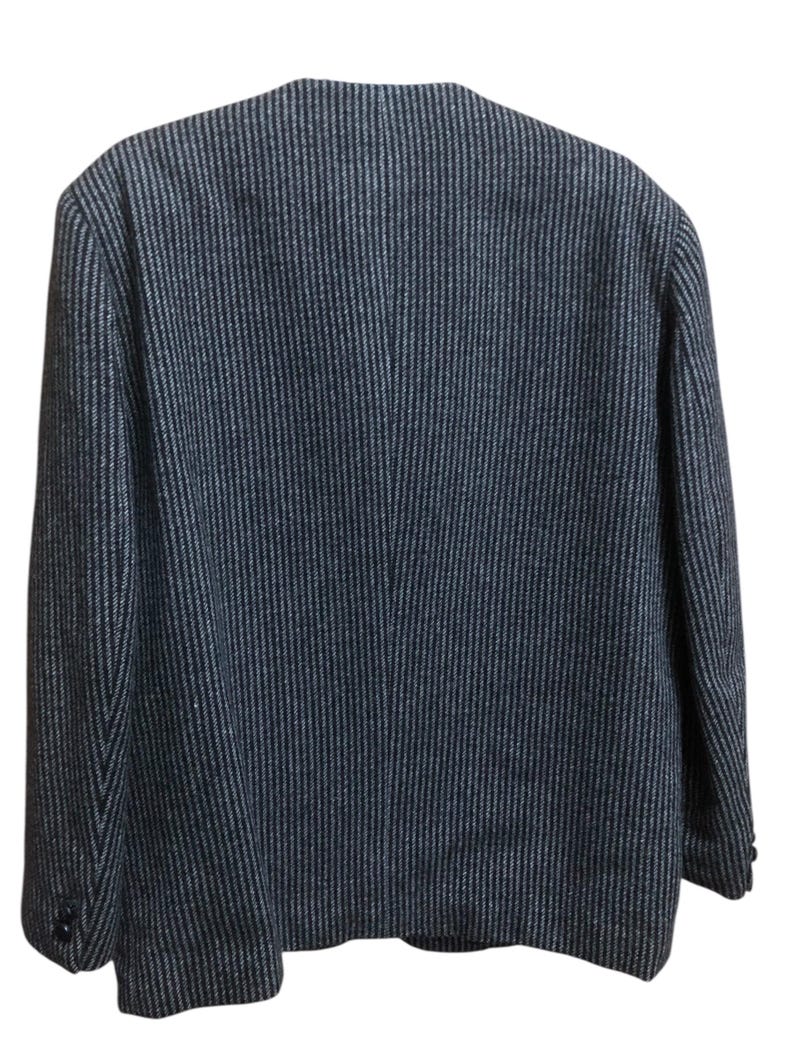 May include: Back view of a dark blue blazer with a subtle vertical stripe pattern. The blazer has a classic design with a notched collar and buttoned cuffs. The fabric appears to be a textured weave, suitable for cooler weather.