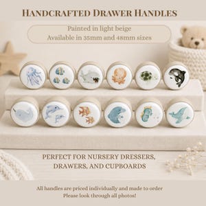 May include: Twelve round drawer handles with light beige edges and white centres featuring watercolour illustrations of sea creatures including a jellyfish, fish, shark, octopus, turtle, orca, narwhal, dolphins, seahorse, and whale. Text reads Handcrafted Drawer Handles.