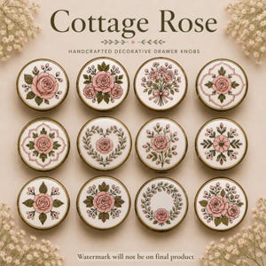 May include: Twelve round drawer knobs featuring Cottage Rose designs. Each knob has a white background with pink rose illustrations, green leaves, and gold-toned metal rims. The patterns include bouquets, wreaths, hearts, and geometric floral motifs.