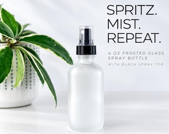 May include: A 4 oz frosted glass spray bottle with a black spray top. The text on the image reads: SPRITZ. MIST. REPEAT. 4 OZ FROSTED GLASS SPRAY BOTTLE WITH BLACK SPRAY TOP. The bottle has a smooth, translucent finish and a black plastic nozzle.