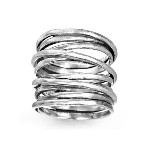 May include: A silver ring with a unique design of multiple intertwined bands. The ring is thick and has a textured finish.