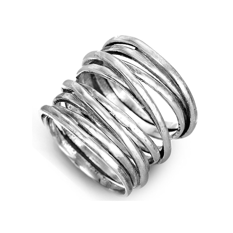 May include: Silver ring with multiple bands twisted and woven together. The ring is thick and has a rustic, hammered finish.