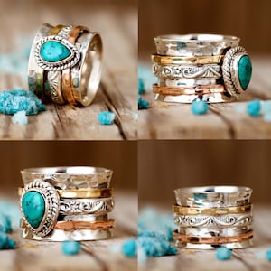 May include: A silver spinning ring with a turquoise gemstone. The ring has multiple bands of silver, copper, and gold.