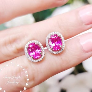 May include: A set of three ceramic mugs with a speckled, matte finish. Each mug features a different color: light blue, cream, and gray. The mugs have a simple, modern design with a rounded shape and a handle.