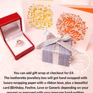 May include: A red jewelry box with a ring, a small gray gift box with a silver bow, and two greeting cards with floral cutouts. One card says "Happy Birthday" and the other says "Just for You".