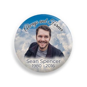 May include: A memorial button with a photo of a man against a blue sky with clouds. The text reads "Always and Forever Sean Spencer 1980 - 2016".