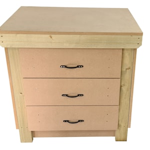 May include: A wooden workbench with three drawers and a top surface. The drawers have black metal handles. The workbench is made of unfinished wood.