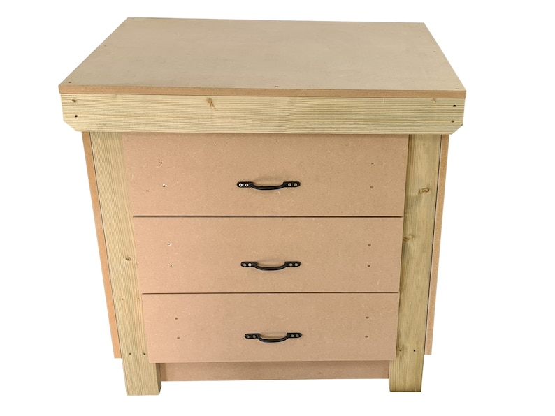 May include: A wooden workbench with three drawers and a top surface. The drawers have black metal handles. The workbench is made of unfinished wood.