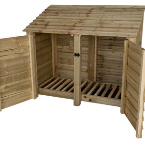 May include: A wooden log storage shed with a slanted roof and two hinged doors. The shed has a slatted floor and is open to reveal the interior.