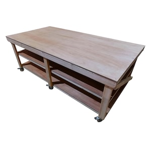 May include: A wooden workbench with two shelves and four wheels. The workbench is made of natural wood and has a light brown finish.