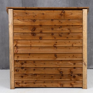 May include: A wooden bar counter with a natural brown finish. The counter is made of horizontal planks of wood.