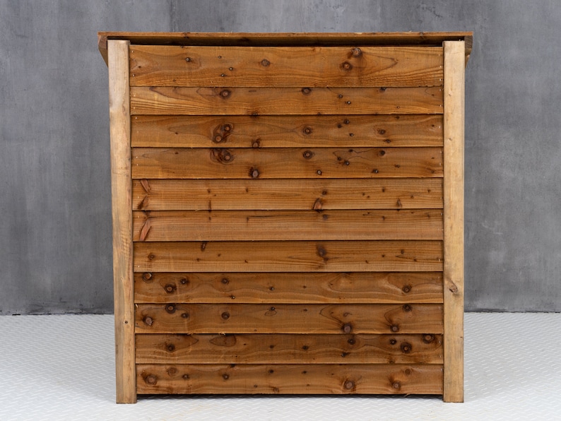 May include: A wooden bar counter with a natural brown finish. The counter is made of horizontal planks of wood.