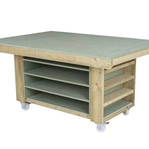 May include: A wooden work table with a green top and three shelves. The table is on wheels and has a light wood finish.