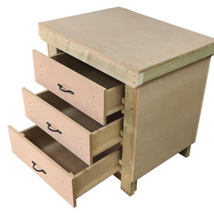 May include: A wooden workbench with three drawers. The drawers are open and the workbench is made of natural wood.