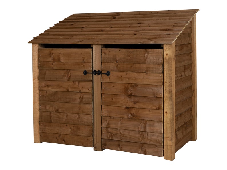 May include: A brown wooden double-door bin storage with a slanted roof. The bin storage has two doors with black metal latches.