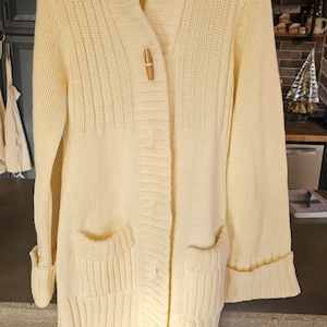 Vintage 1970s era cream knit cardigan with toggle buttons. Long sleeved. Ladies size medium. FREE SHIPPING