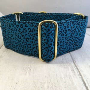 May include: A blue and black leopard print dog collar with gold metal hardware.